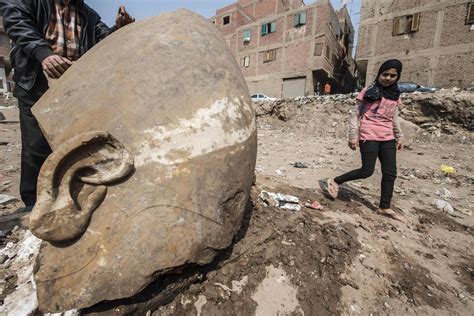 massive statue of ancient egyptian pharaoh found in city slum