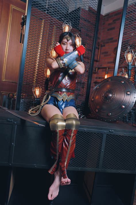 1419205 Asian Wonder Woman Hero Cosplay Sitting Pose Hands Legs