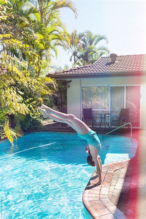 girl doing a handstand into the pool by gillian vann handstand pool