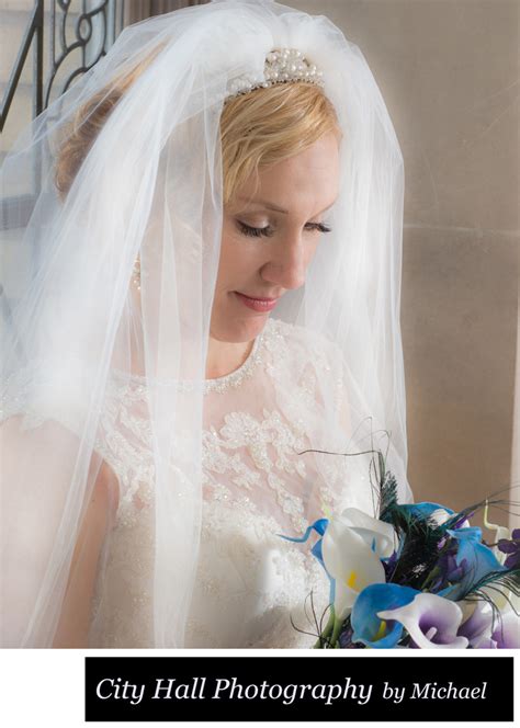 bride bouquet with face framed by veil in natural light krista and