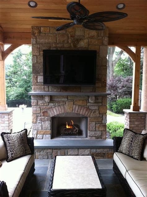 stone  wide hearth   tv  outdoor fireplace