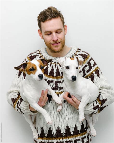 man holding  dogs  stocksy contributor duet postscriptum stocksy