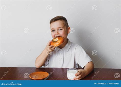 boy  eating  bagel  drink milk stock photo image  bakery