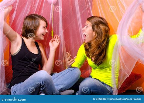 two teenage girls having fun on the bed stock image image of
