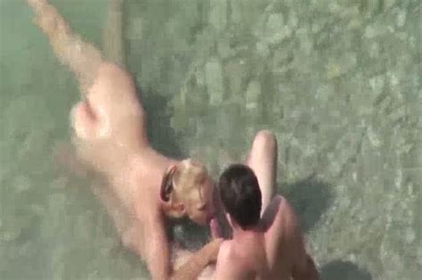 blondie on the nude beach gives blowjob to her man