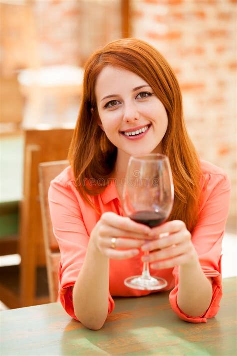 beautiful redhead girl with a glass of red wine stock image image of