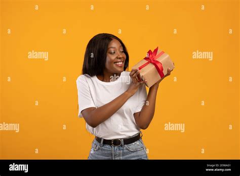 happy african american woman holding gift box stock photo alamy