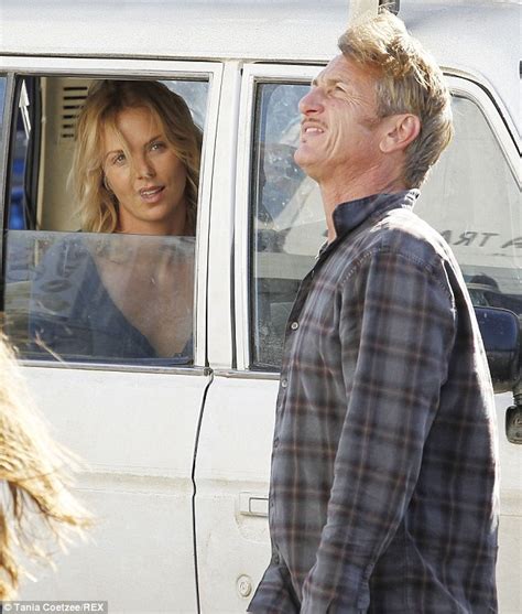 charlize theron giggles with sean penn after he gets stuck on a boom lift during filming of the