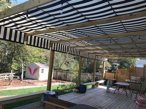 custom built structure  strip track  black  white striped retractable canopies added