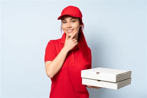 premium photo pizza delivery girl holding a pizza over isolated happy