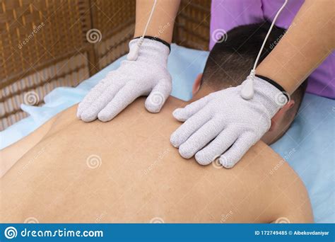 Man Having Back Massage Physiotherapy With Gloves Stock Image Image