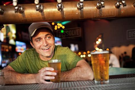 caucasian man drinking beer  bar stock photo dissolve