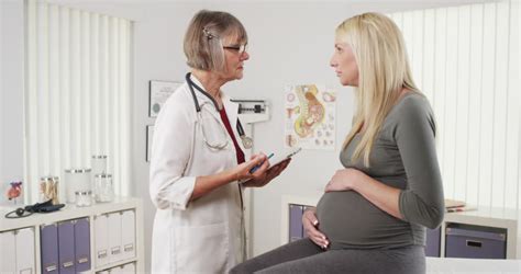 Pregnant Woman Talking To Doctor Stock Footage Video