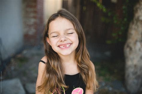 A Candid Portrait Of A Girl Missing Her Teeth By Stocksy Contributor