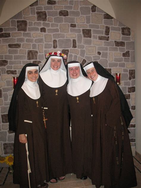 three women dressed in nun costumes standing next to each other with