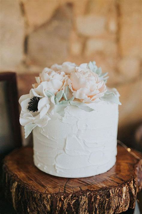 single tier white buttercream wedding cake topped with pastel sugar