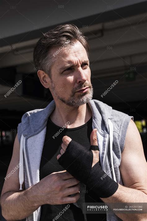 man bandaging hands for boxing training — sportive athlete stock