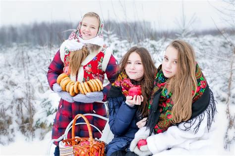 beautiful teen girl in russian national clothes with red apples in winter hands stock image