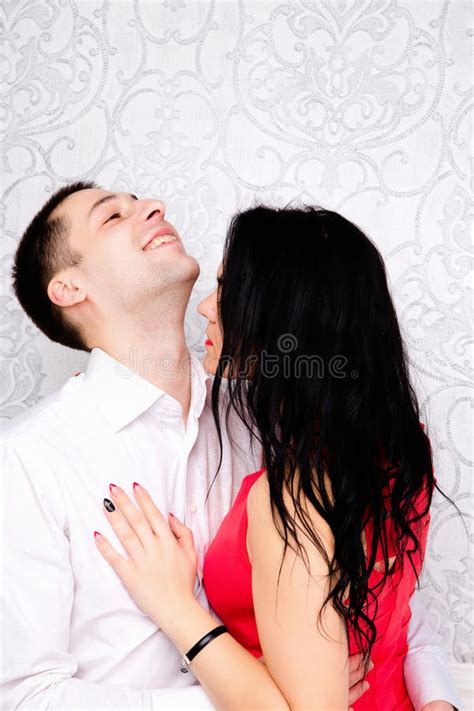Beautiful Impassioned Couple Kissing In Bed At The Hotel