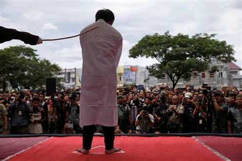 two men publicly caned in indonesia for having gay sex