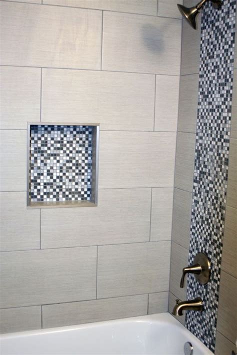 Bathroom shower with gray and white square mosaic and 12