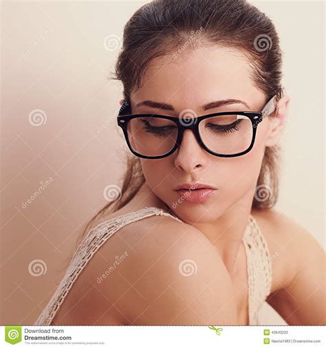 beautiful woman in fashion glasses looking down stock