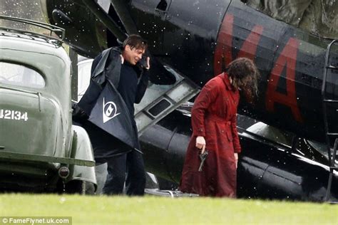 brad pitt struggles with his umbrella while filming scenes for his