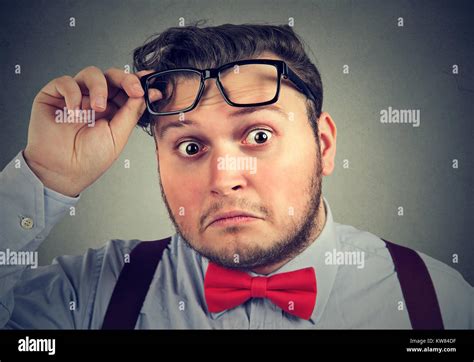 Young Chubby Man Taking Off Glasses And Looking At Camera With Big
