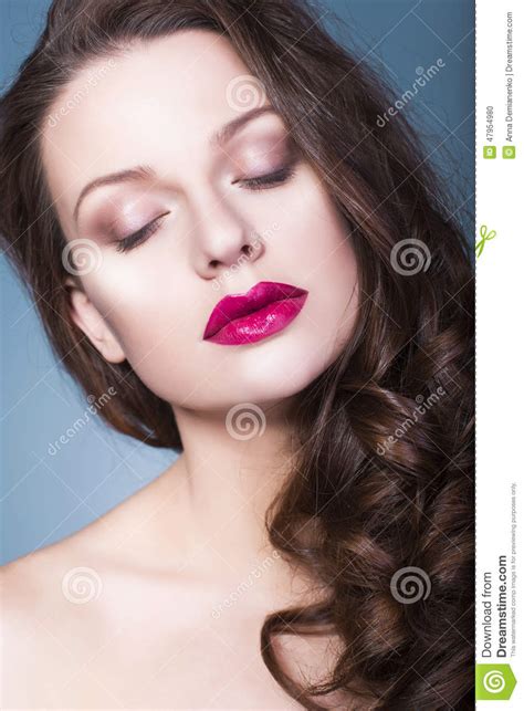 brunette woman with creative make up violet eye shadows