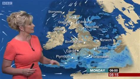Carol Kirkwood Pours Her Voluptuous Curves Into Plunging Coral Dress