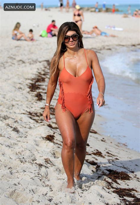 teresa giudice in a peach one piece swimsuit as she takes a stroll