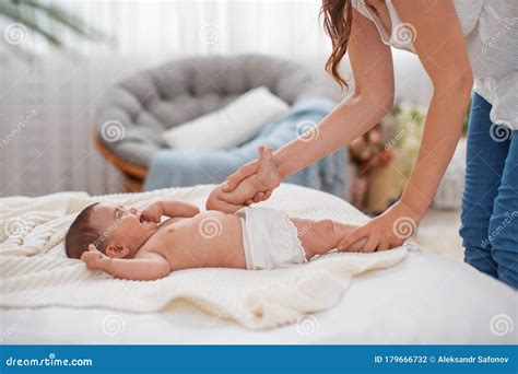 baby massage mom  gymnastics  massages  cute newborn baby stock photo image