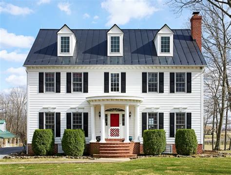traditional center hall colonial  white painted exterior  black metal roof colonial