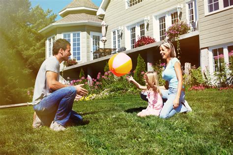 family playing  front lawn dbi brokers