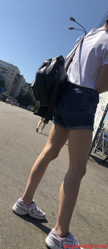 cute gilr with thin legs in blue denim shorts street
