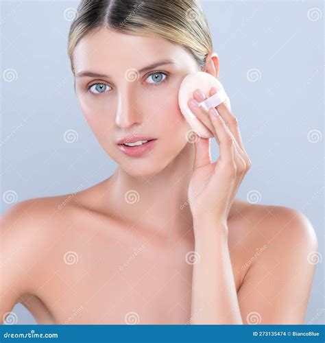 Alluring Beautiful Female Model Applying Powder Puff For Facial Makeup
