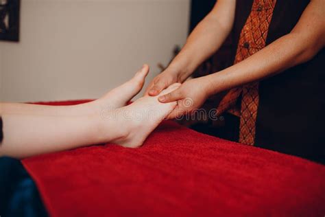 Thai Man Making Classical Feet Thai Massage Procedure To Young Woman At