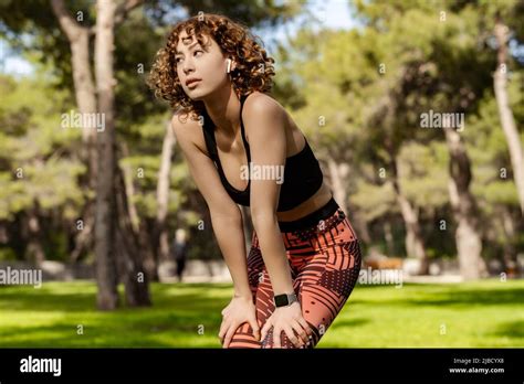 Beautiful Redhead Woman Wearing Sportive Clothes Standing On City Park