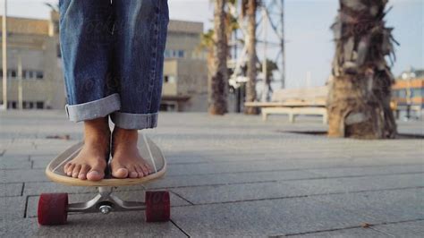 closeup   barefoot girl skateboarding   longboard  stocksy contributor