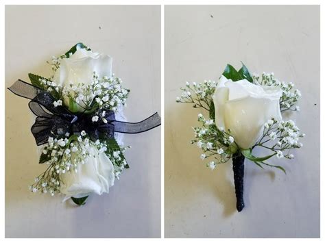 white  black corsage  boutonniere  white roses babys breath green leaves black