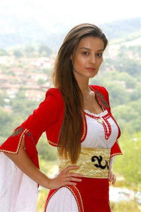A Beautiful Woman In A Red And White Costume Posing For A Photo With