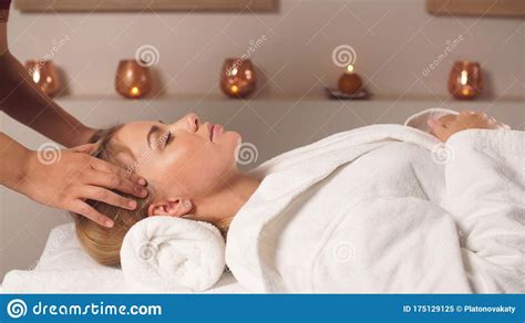 The Masseur Gives A Facial Massage To A Pretty Woman Spa Stock Image