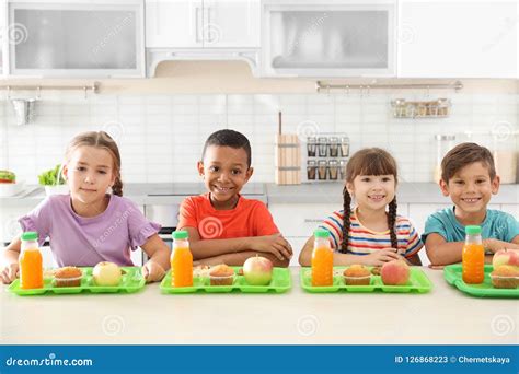 children sitting  table  eating healthy food stock image image