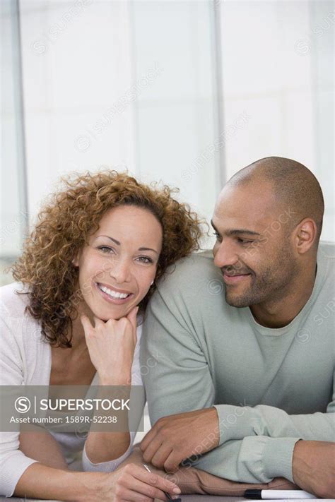 African Couple Laying On Floor Superstock