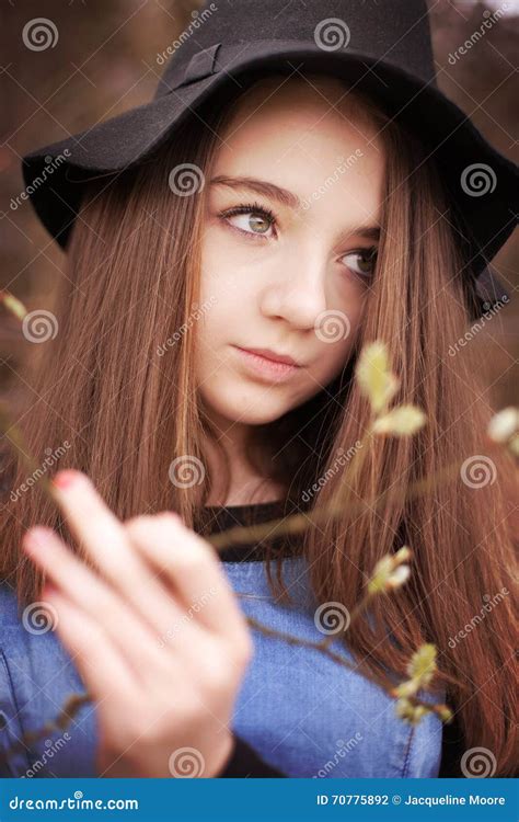 beautiful teenage girl holding  branch  blossom stock photo image