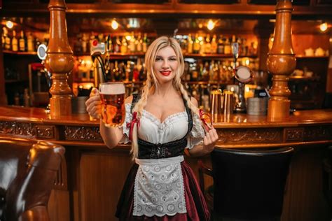Premium Photo Sexy Waitress Holds Two Mugs Of Fresh Beer At The