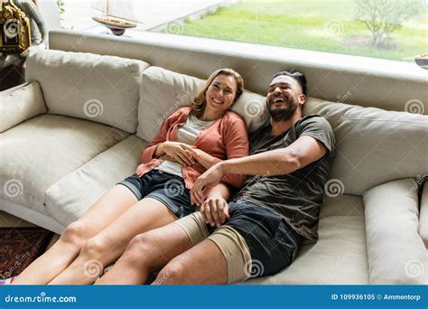 Smiling Young Couple Relaxing On Sofa Stock Image Image Of Smiling