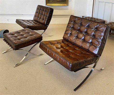 barcelona chairs  pair buttoned brown leather   framed chrome supports