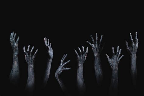 scary  creepy zombie hands raising  darkness photograph