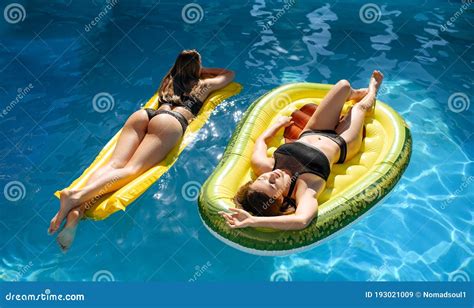 women sunbathing  mattress   pool stock image image  person happiness